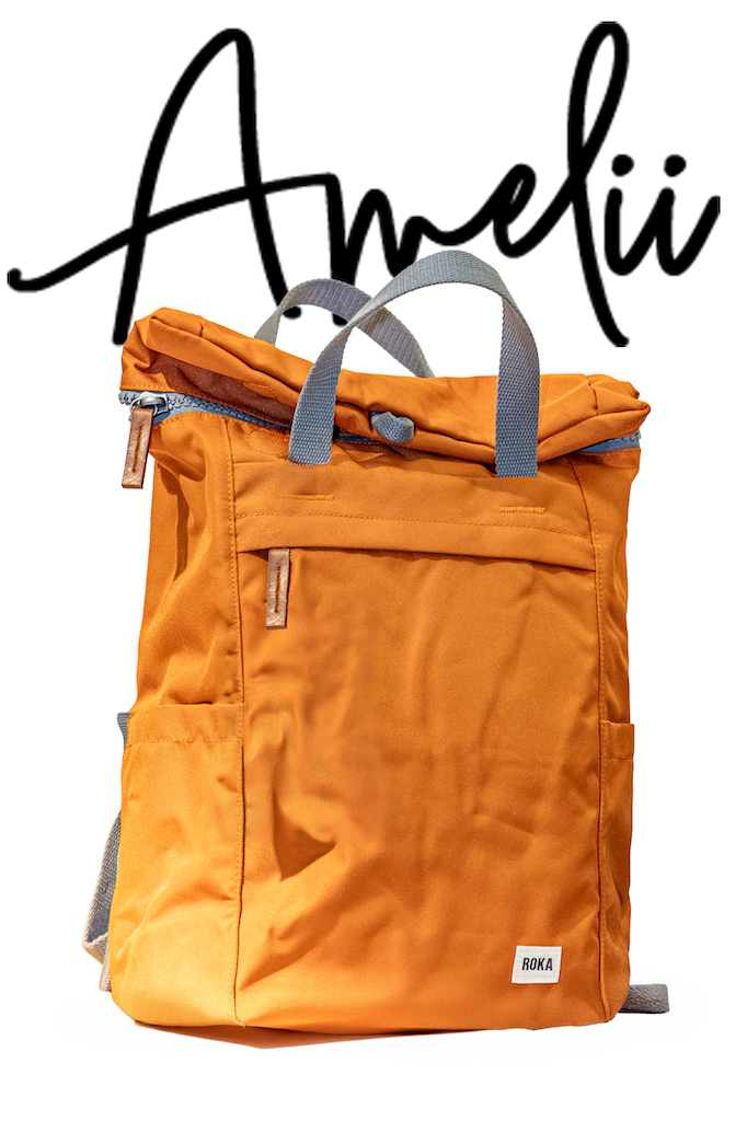 Oranssi ROKA-reppu valkoisella taustalla ja Amelii-logo – Amelii Kenkä & Laukku